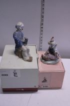 Two boxed Nao figurines