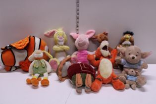 A large job lot of assorted Disney and other soft toys