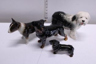 Four Cooper craft ceramic dog figures