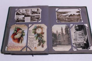 A antique postcard album with good selection of assorted postcards