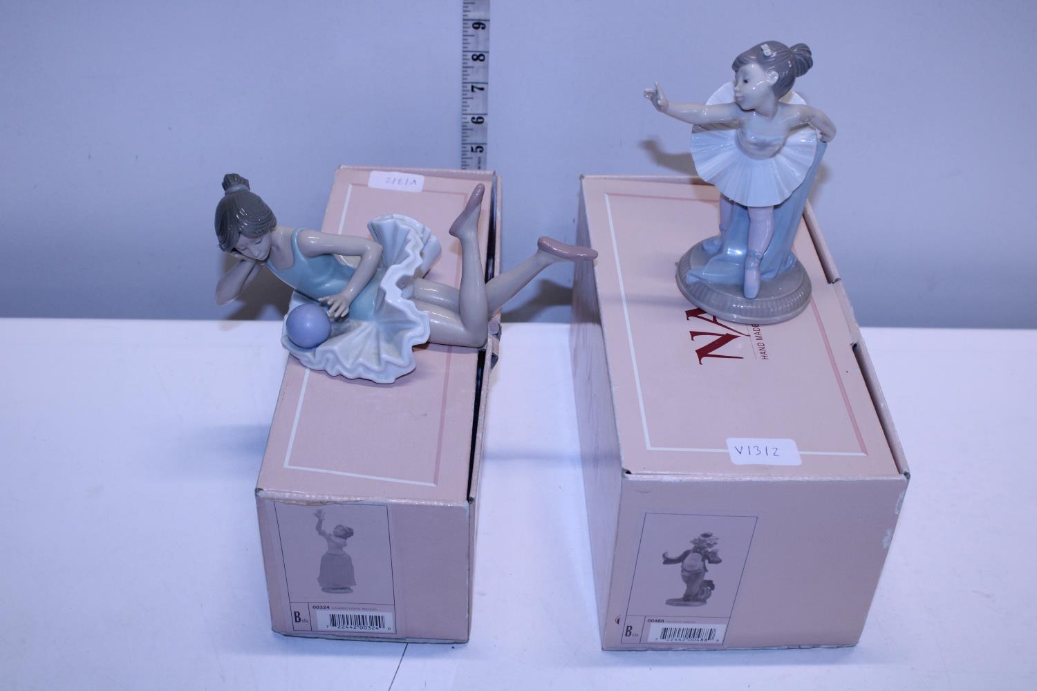 Two boxed Nao figurines