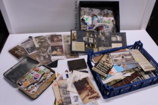 A job lot of assorted mixed stamps postcards and other ephemera