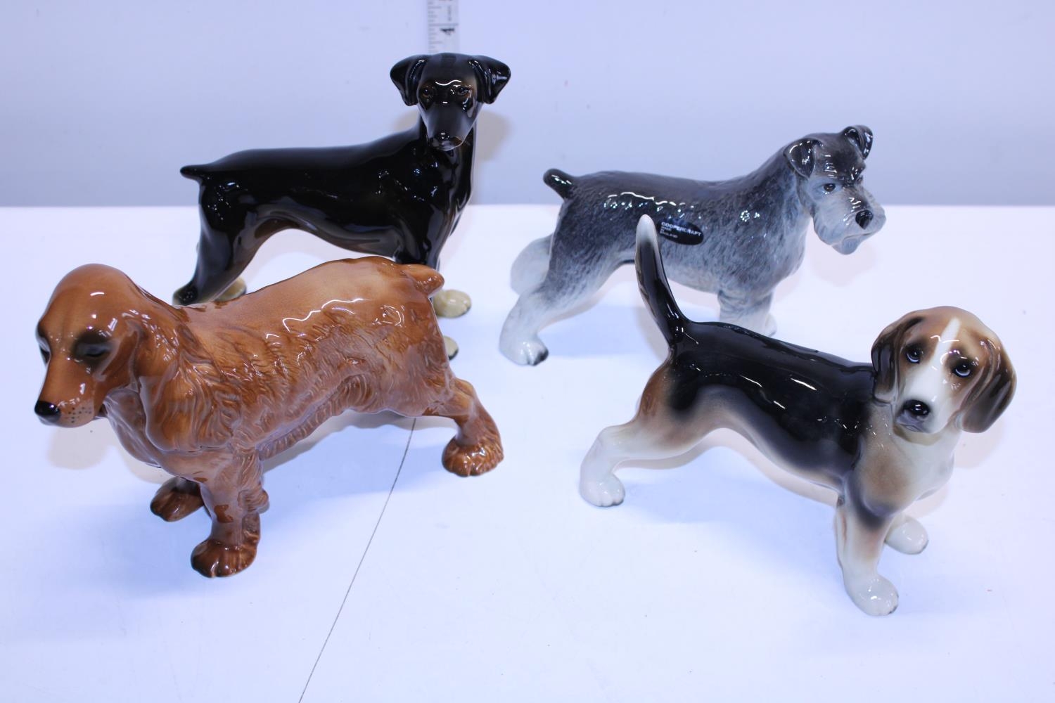 Four Cooper craft ceramic dog figures