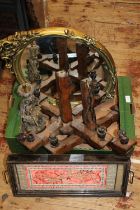 A box of items including wooden candelabras, a gilt mirror and a tray with embroided decoration