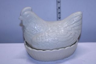 A white ceramic chicken form egg basket shipping unavailable