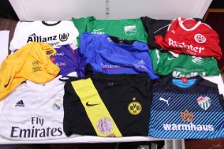 A box of assorted football shirts