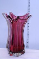 A large heavy cranberry glass art glass vase