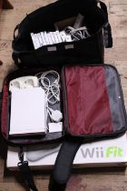 A Wii console, Fit board accessories and games