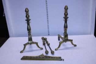 A pair of Victorian brass fire dogs and accessories. Shipping not available.