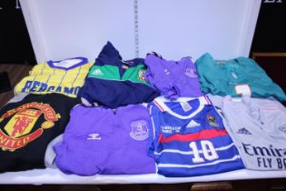A selection of assorted football shirts and other