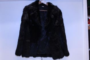 A ladies black fur coat
