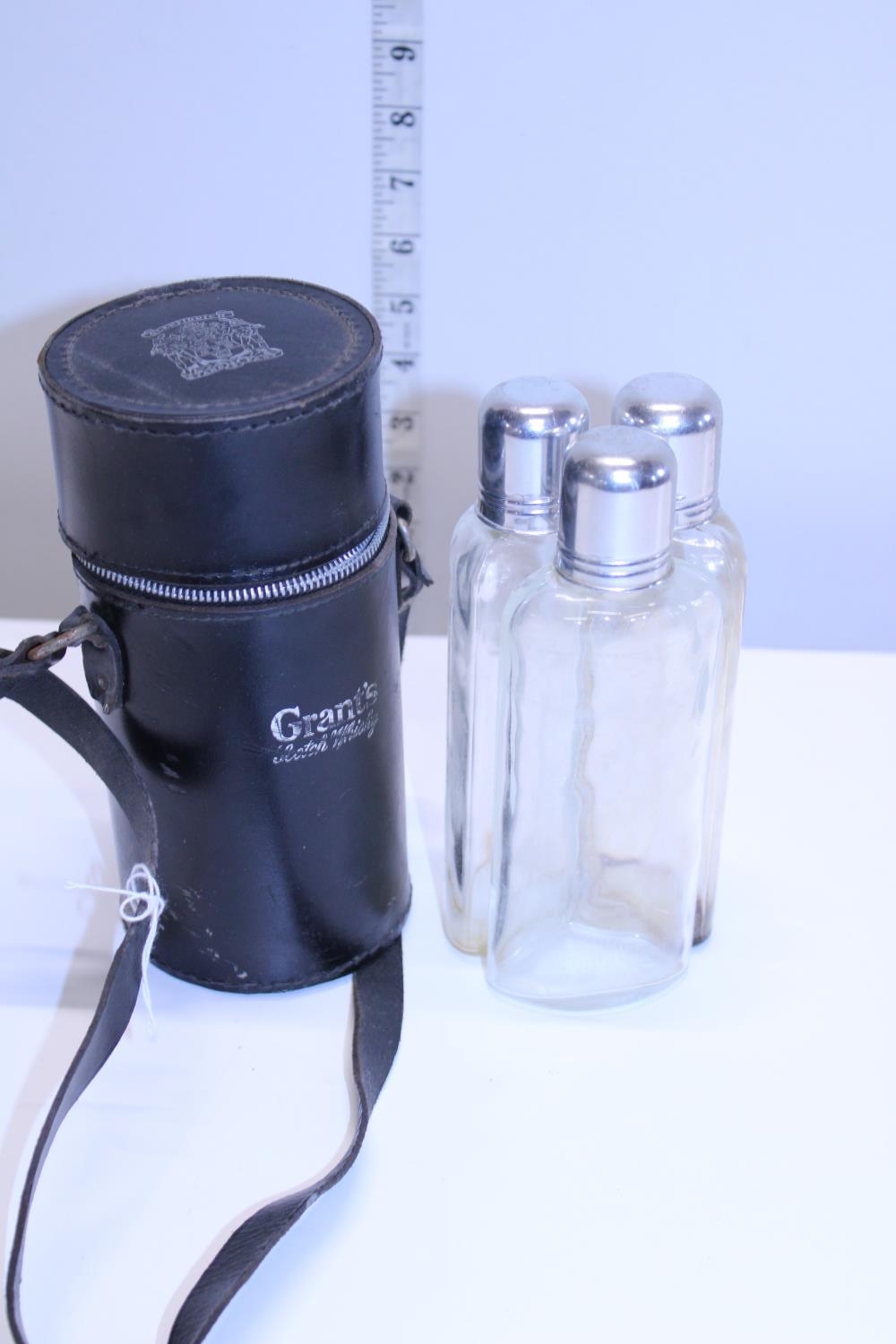 A Grant's three bottle hip flask in leather case