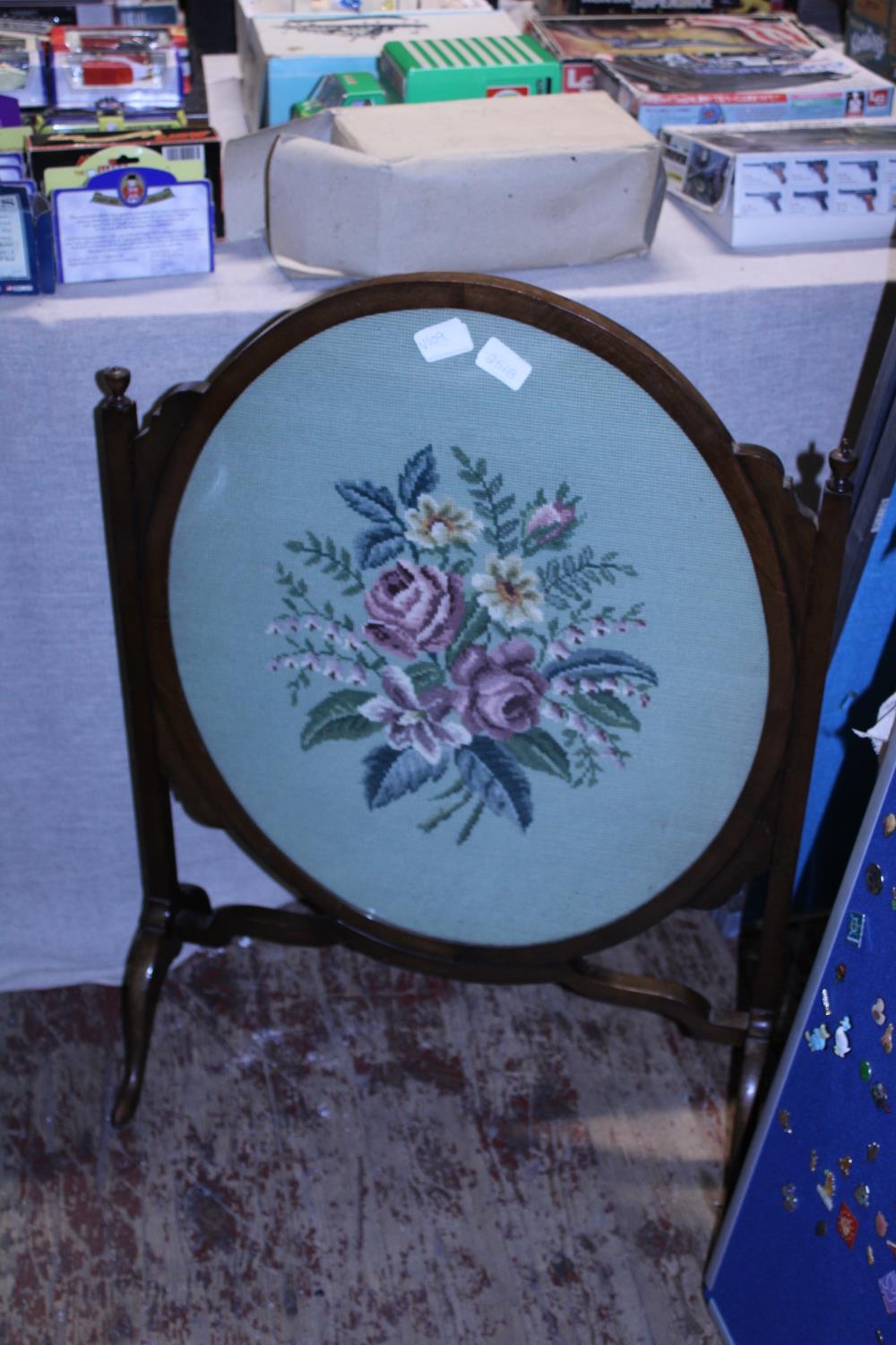 A early Edwardian embroidered fire screen, shipping unavailable