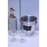 A vintage aluminium champagne bucket, vintage soda syphon and two cut glasses