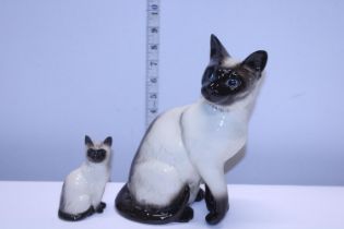 A large Beswick Cat and a smaller Royal Doulton cat