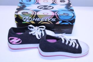 A boxed pair of Heelys size 2