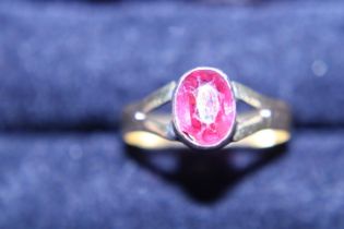 A 22ct gold antique ring with a pink sapphire central stone. 2.35g. Size P