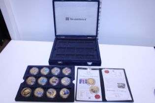 A selection of assorted commemorative coins with COA's