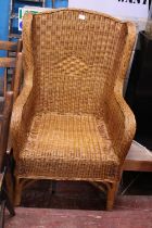 A vintage wicker work wingback arm chair. shipping unavailable
