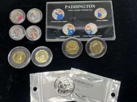 A box set of collectable Paddington bear 50p's and a selection of Beatrix Potter 50p's along with
