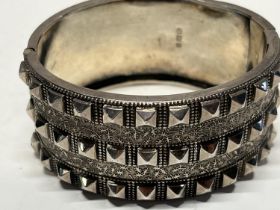 A hallmarked silver cuff bracelet with stud decoration. 42.57 gms & 5.5cm internal diameter.