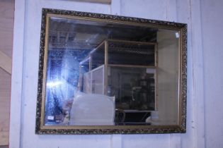 A large ornate gilt framed bevelled edge mirror 112x87cm, shipping unavailable