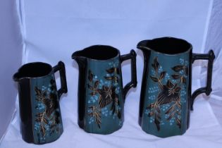 Three antique graduated jugs