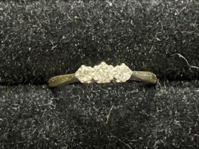 A 18ct gold and platinum three stone ring size N 1/2, 2.03g