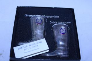 A boxed set of drinking measures in the form of boots