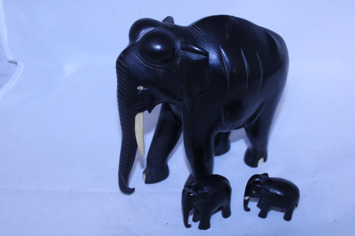 Three antique ebony elephants