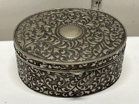A heavy metal jewellery box with ornate decoration