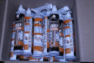 A box full of new tubes of Anchoring Adhesive