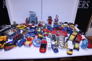 A large wooden box with contents of toys die-cast models and other