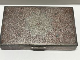 A ornately decorated white metal box with red enamel decoration