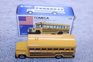 A boxed Tomica F5 die-cast model