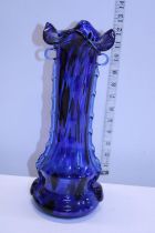 A large blue art glass vase