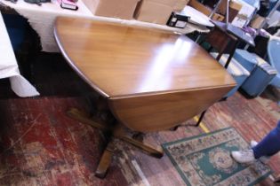 A mid-century Ercol drop leaf dining table. Shipping unavailable.