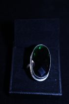 A sterling silver and green stone ring
