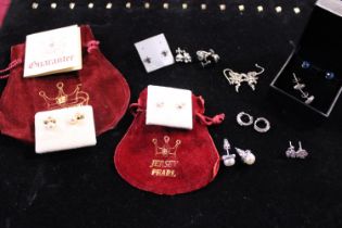 A large selection of assorted silver earrings