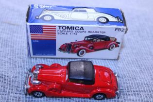 A boxed Tomica F52 die-cast model