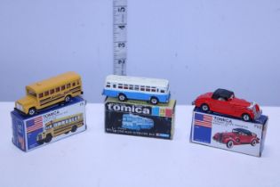 Three boxed assorted Tomica die-cast models
