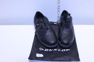 A pair of new Dunlop golf shoes size 11