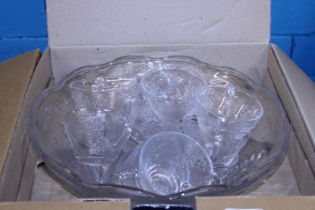 A boxed as new glass punch bowl and glasses