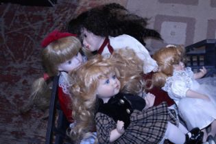 A job lot of assorted dolls with stands