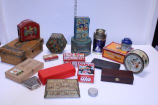 A box of assorted vintage tins and other items