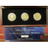 A Westminster Coronation Jubilee three coin silver five pound proof set. Each coin weighs 28.28