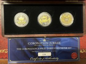 A Westminster Coronation Jubilee three coin silver five pound proof set. Each coin weighs 28.28