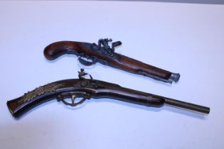 Two wooden wall hanging pistols