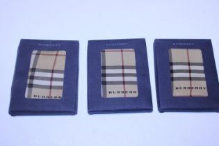 Three boxed Burberry silk scarves 45x45cm