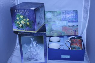 Two boxed flower arranging displays and a set of four Claude Monet themed mugs